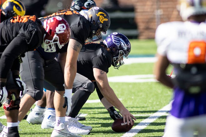 Offensive lineman Quinn Meinerz of Wisconsin -Whitewater (with football) gets set at the line during practice at Hancock Whitney Stadium.