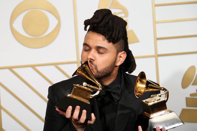 The Weeknd, winner of the Best R&B Performance award for 'Earned It,' and Best Urban Contemporary Album award for 'Beauty Behind The Madness,' poses in the press room during The 58th GRAMMY Awards at Staples Center  on February 15, 2016 in Los Angeles, California.