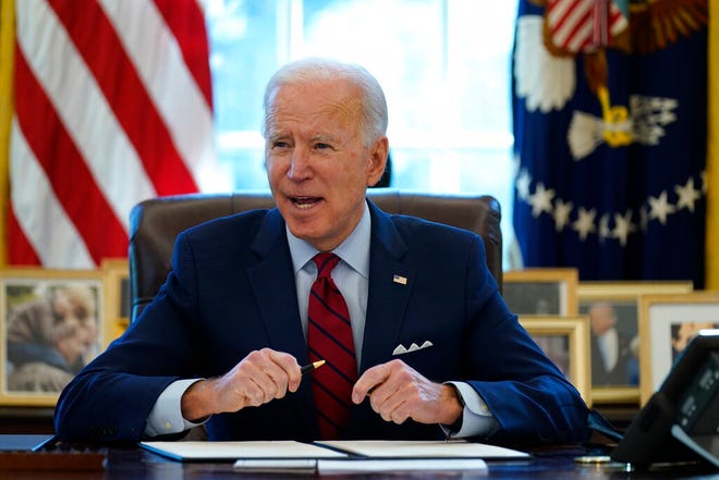 President Joe Biden signs a series of executive orders on health care Thursday in the Oval Office of the White House. The Democratic push to raise the minimum wage to $15 an hour has emerged as an early flashpoint in the push for a $1.9 trillion COVID relief package, providing an early test of President Joe Biden's ability to bridge Washington's partisan divide in pursuing his first major legislative victory.