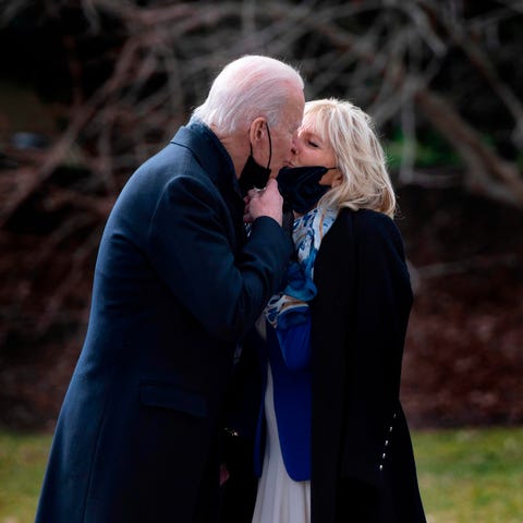 President Joe Biden kisses first lady Jill Biden a
