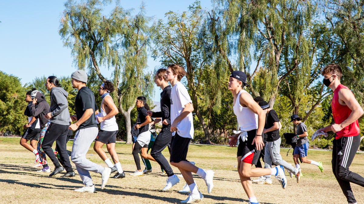 High school athletes jog to the next combine portion of their tryout during the Desert Diablos club football team at La Quinta Park in La Quinta, Calif., on January 30, 2021. 