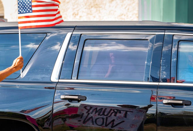 Former President Donald Trump passes supporters while traveling in his motorcade in West Palm Beach, Fla., on Wednesday, Jan. 27, 2021, on his way to Mar-a-Lago in Palm Beach. (Greg Lovett/The Palm Beach Post via AP)