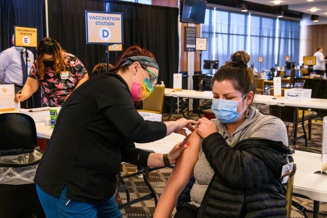 Workers receive their shots at the MU Health Care mass COVID-19 vaccination site in the Walsworth Club at Memorial Stadium.