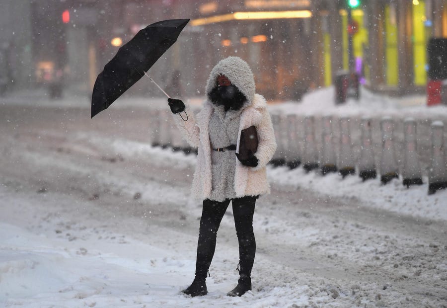 A woman holds an umbrella in Times Square during a winter storm on Feb. 1, 2021 in New York City.