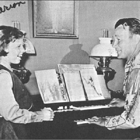 A young Mimi Rogers Swift sings as her father, Roy