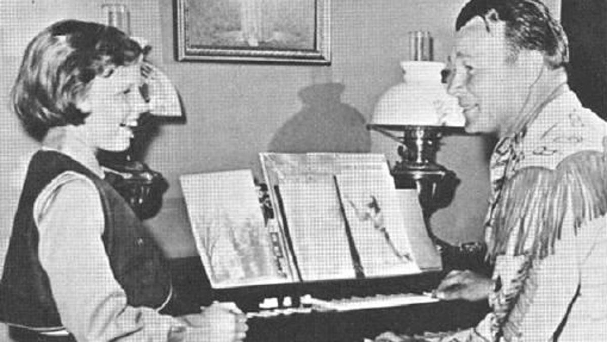 A young Mimi Rogers Swift sings as her father, Roy Rogers, accompanies her on the piano in an undated photo.