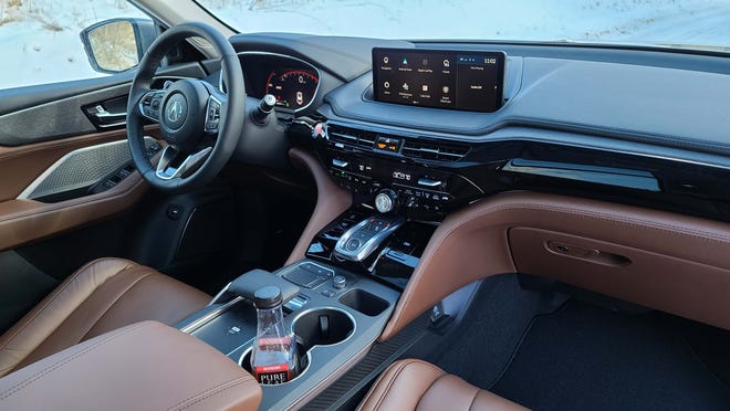 The interior of the 2022 Acura MDX includes a wealth of standard features including twin digital displays, trigger shifter with Drive modes, wireless charger, adaptive cruise control and more.