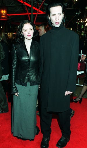 Marilyn Manson arrives at the premiere of Tim Burton's film "Sleepy Hollow" with Rose McGowan in Los Angeles, Nov. 17, 1999.