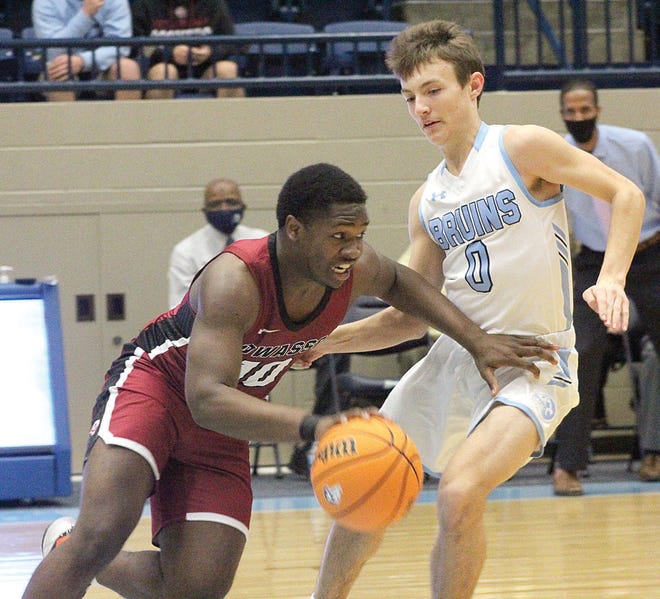 Bartlesville High guard Kaden Brown, right, tries to obstruct the path of an Owasso Rams' dribbler during Tuesday's varsity action at the Bruin Fieldhouse.