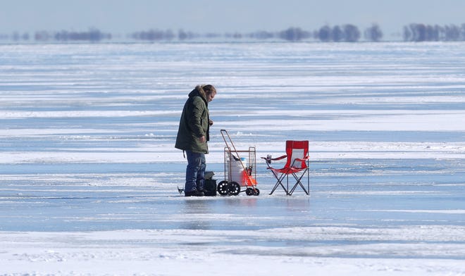 A fisherman is seen near the DNR launch at Selfridge Air National Guard base  Wednesday, February 3, 2021.