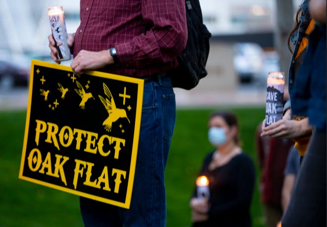 Supporters of Apache Stronghold participate in a candlelight vigil at Arizona Chamber of Commerce to save Oak Flat. The group opposes a copper mine that would obliterate the sacred site.