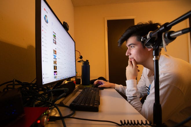 Topekan Pancho Witt, known on social media as just "Pancho," scrolls through his YouTube channel Wednesday at his apartment, as he explains what has made his videos successful. As of Feb. 4, Witt has more than 275,000 subscribers.