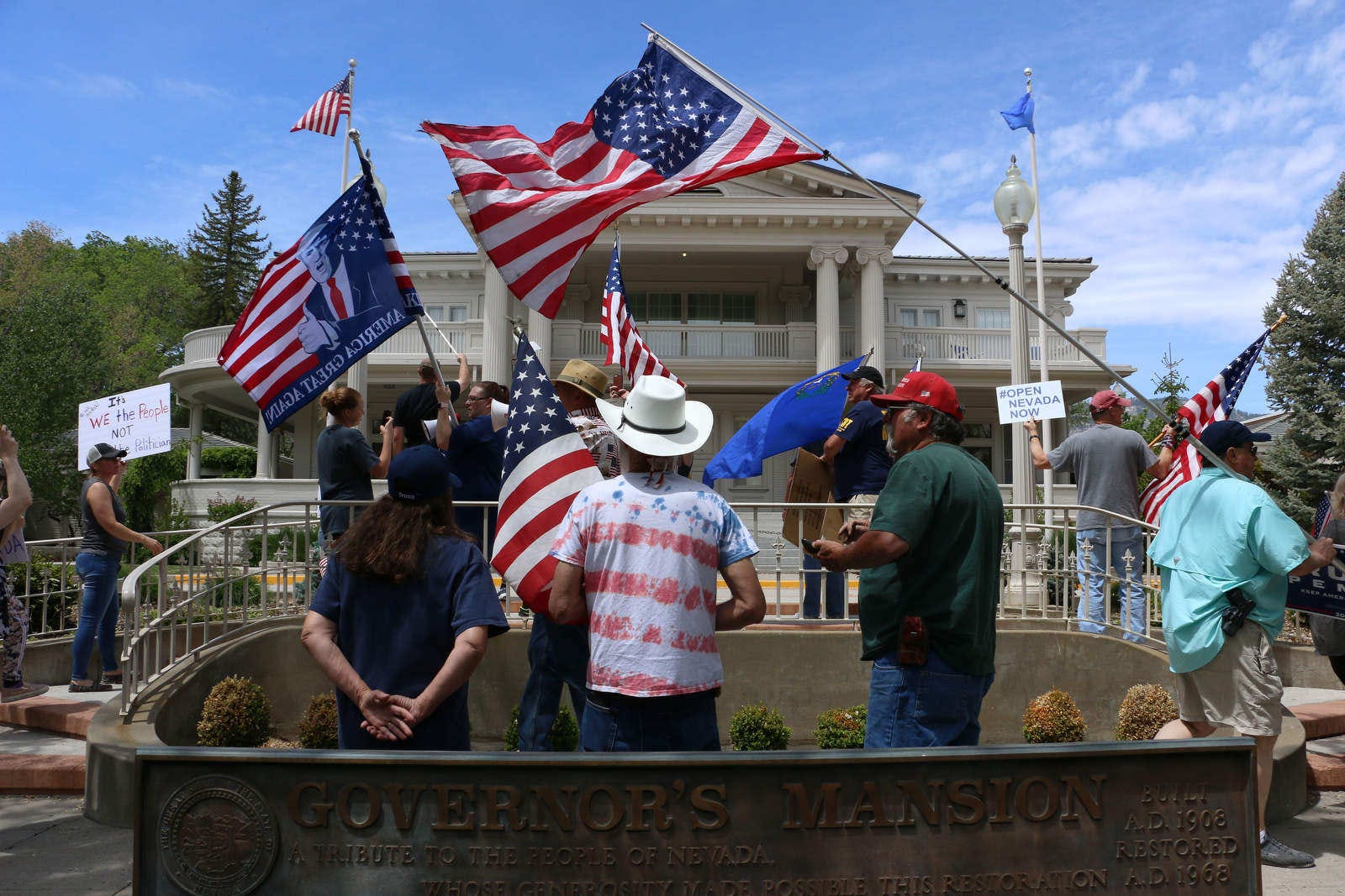 People gather in Carson City and march to the Governor's Mansion to demand the reopening of Nevada's economy on May 16, 2020.