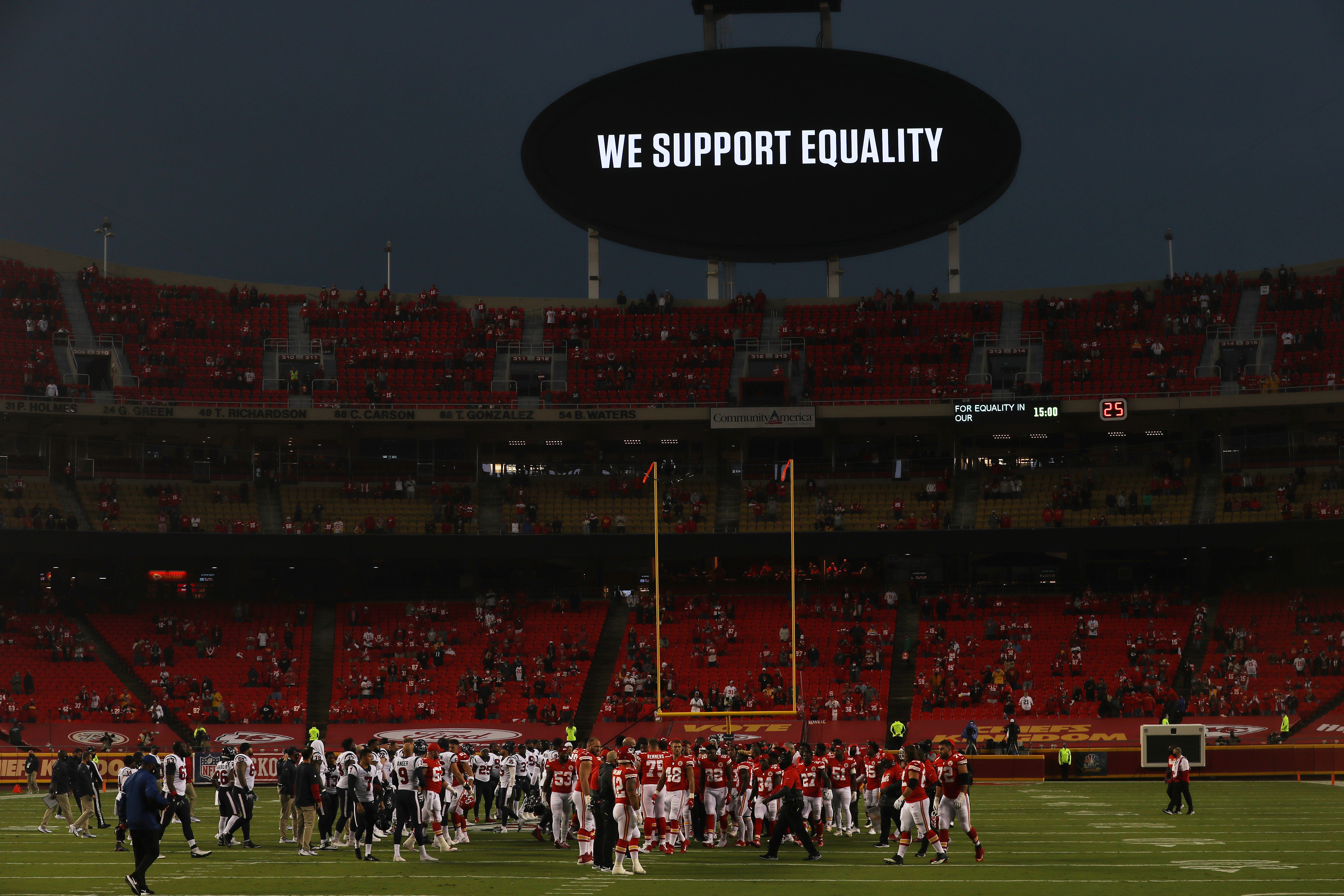 Players from the Kansas City Chiefs and Houston Texans unite in a moment of silence before the start of a game in September.