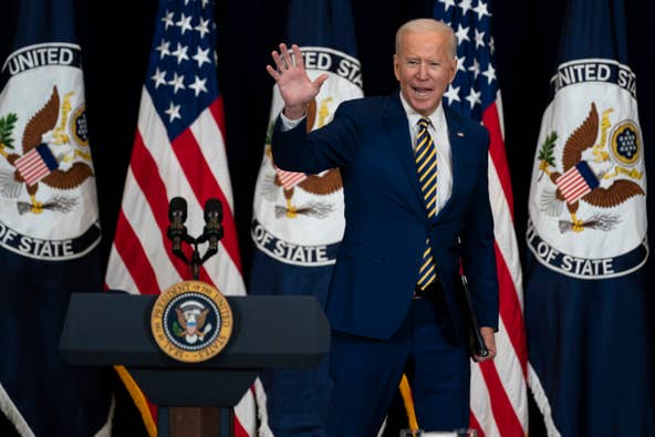 President Joe Biden waves after delivering remarks to State Department staff, Thursday, Feb. 4, 2021, in Washington.