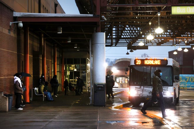 Passengers wait for buses at the MATA William Hudson Transit Center in Uptown on Thursday, Feb. 4, 2021