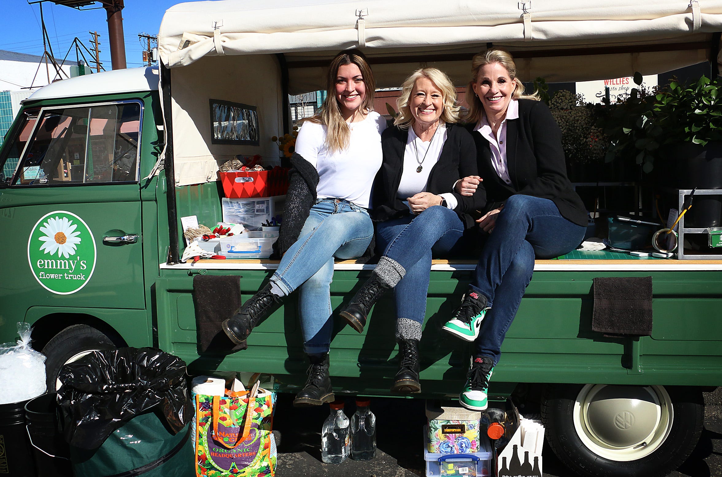 From right, Emily MacPherson, Candy Cruz and Sloan Cruz pose for a portrait in the back of Emmy's Flower Truck at the corner of Virginia St. and Arroyo St. in Reno on Feb. 5, 2021.