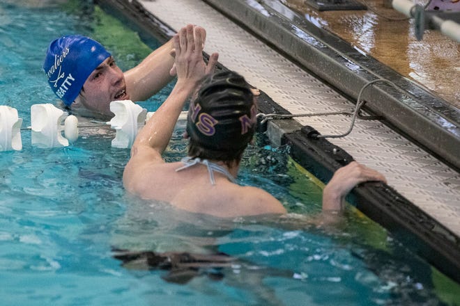 Chillicothe’s James Beatty congratulates another swimmer after the finish of the boys 200 yard freestyle at the 2020-2021 Frontier Athletic Conference Championships at the Fayette County YMCA in Washington Courthouse on Feb. 3, 2021. The Chillicothe girls and boys swim teams took first and second place respectively