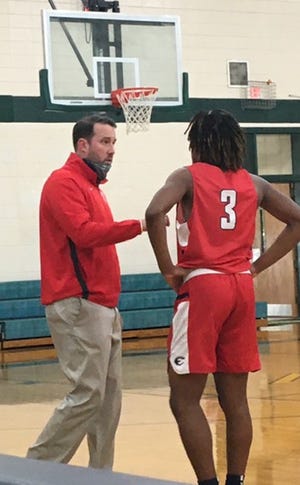 Effingham County boys basketball coach Jake Darling gives instructions to Timmy Brown during a game last season at Savannah Country Day.