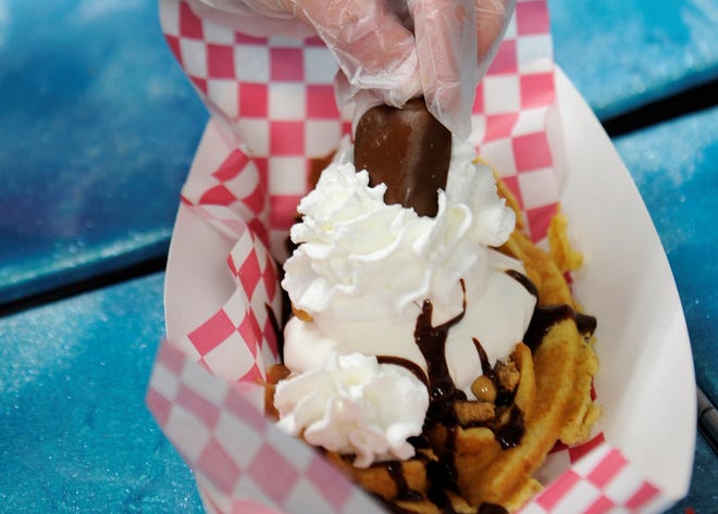A Reese Dreamin' waffle is finished with a whole Reese's cup before being served in the Sweet Dreams À La Mode truck on Friday, Feb. 5, 2021.