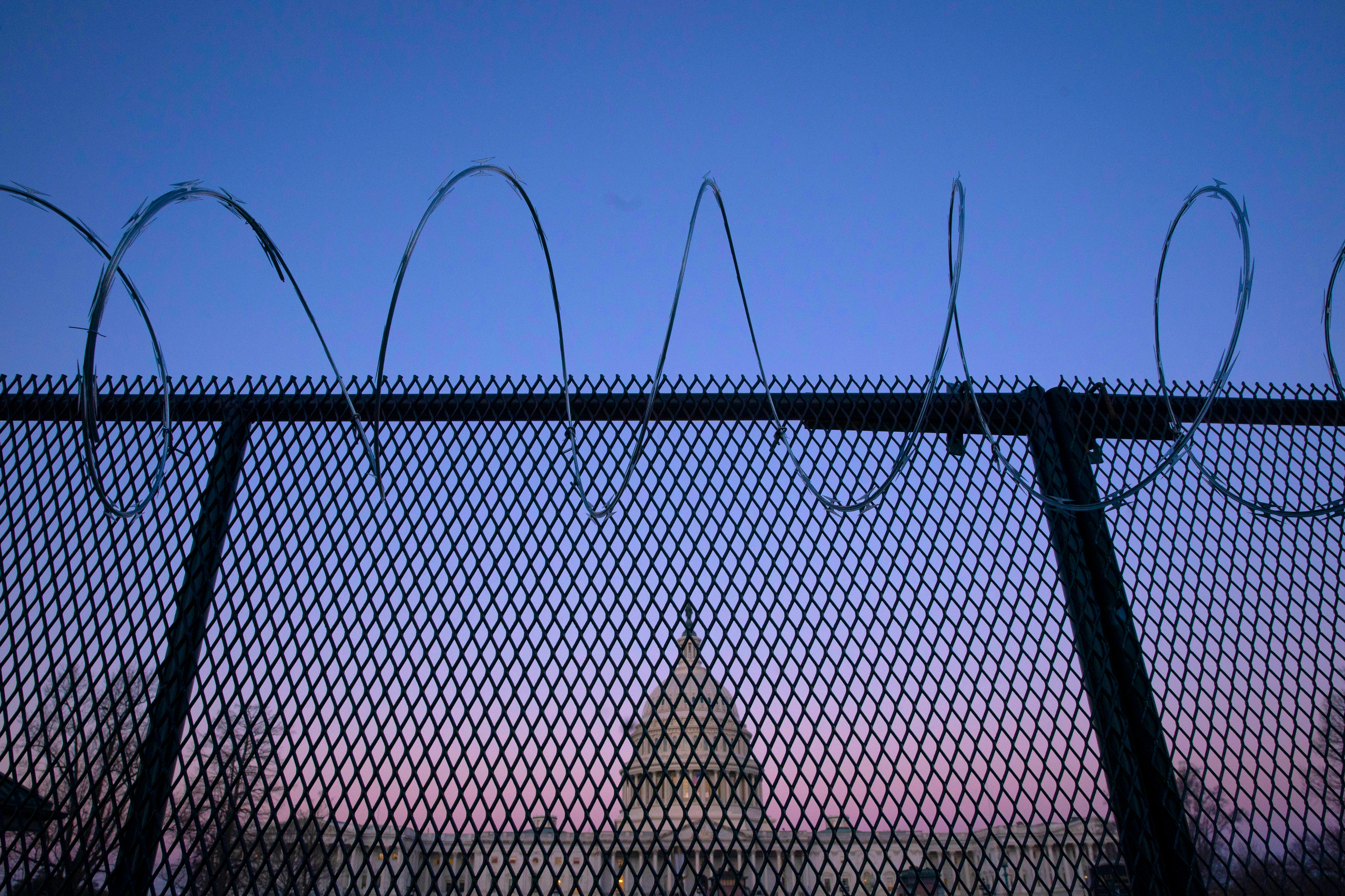 The exterior of the U.S. Capitol building is seen through barbed wire fencing at sunrise on February 8, 2021 in Washington, DC. The Senate is scheduled to begin the second impeachment trial of former President Donald J. Trump on February 9.