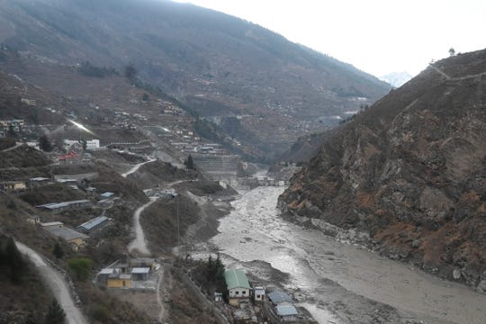 The remains of a dam (center) can be seen along a river in Tapovan in the Chamoli district of Uttarakhand, India, after a flash flood caused by a burst glacier on Feb. 7, 2021.