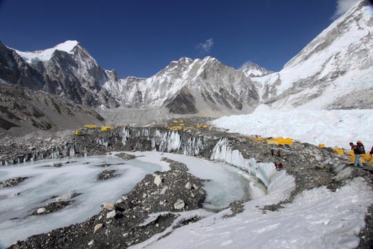 In this April 11, 2015 file photo, tents are seen set up for climbers on the Khumbu Glacier, with Mount Khumbutse, center, and Khumbu Icefall, right, seen in background, at Everest Base Camp in Nepal. The floods that slammed into two hydroelectric plants and damaged villages in northern India were set off by a break on a Himalayan glacier upstream.