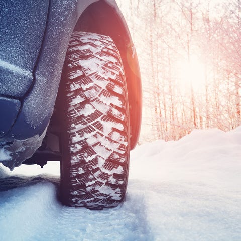 Car tires on winter road covered with snow. Snowy 