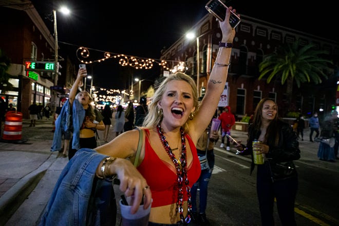 Fans celebrate in the streets of Ybor City in Tampa, Florida, after the Buccaneers beat the Chiefs in Super Bowl 55.