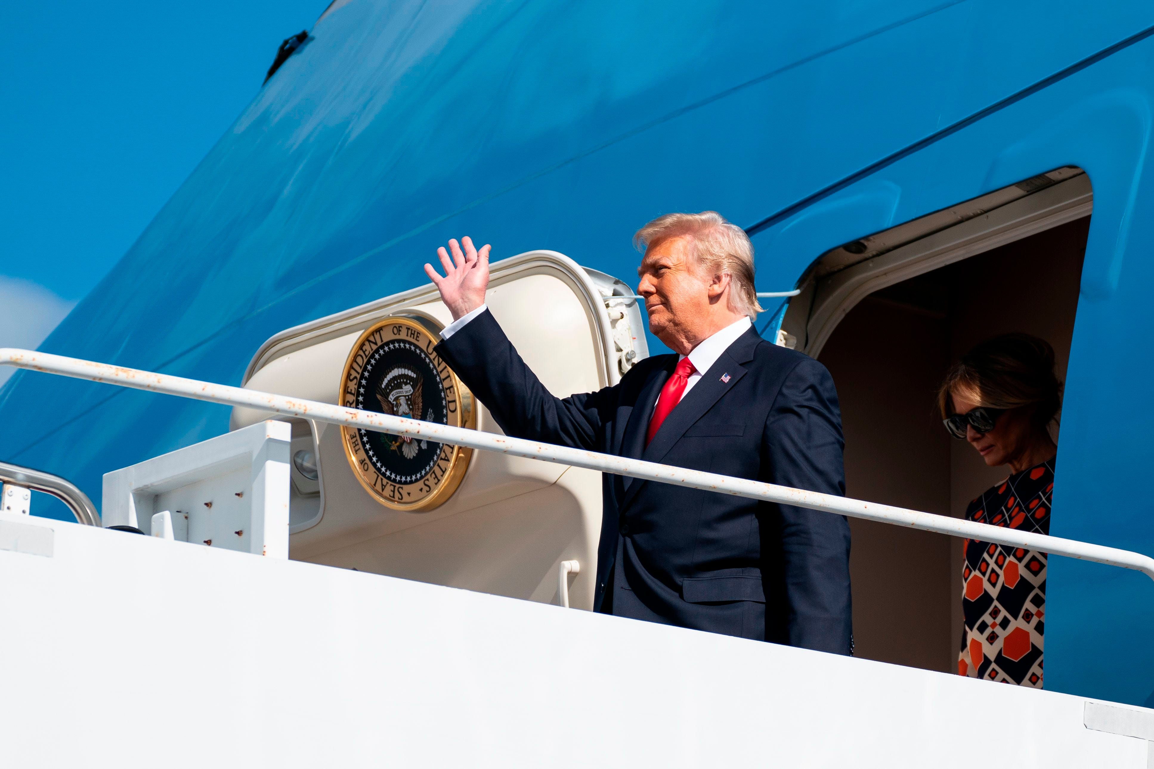 Outgoing President Donald Trump and first lady Melania Trump step off Air Force One as they arrive at Palm Beach International Airport in West Palm Beach, Florida, on January 20, 2021.