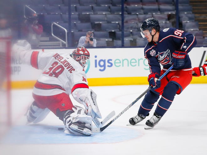 Columbus Blue Jackets center Jack Roslovic (96) beats Carolina Hurricanes goaltender Alex Nedeljkovic (39)] for the game-winning goal during the third period of the NHL hockey game at Nationwide Arena in Columbus on Monday, Feb. 8, 2021. The Blue Jackets won 3-2.