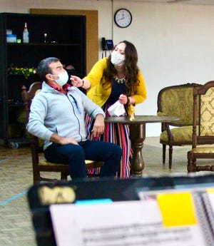 Stefano de Peppo and Anna Mandina, rehearsing in face masks, star in Giovanni Battista Pergolesi’s “Maid to Mistress” at the Sarasota Opera.