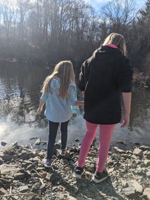 Sisters Grace and Caroline Fitzgibbons study wildlife along the banks of the Eel River as part of their homeschooling curriculum.