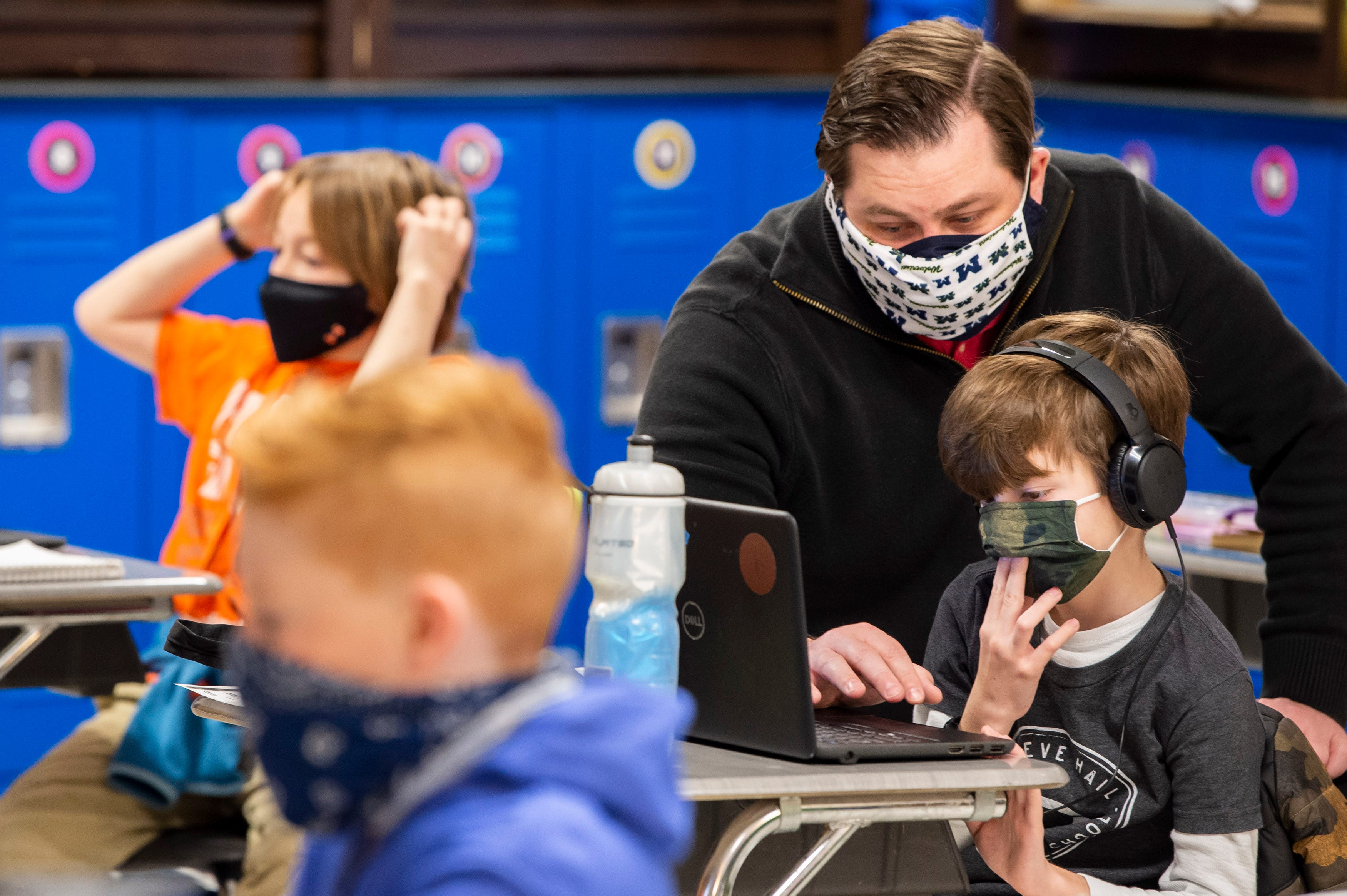 Fourth Grade Teacher Kenneth Knight assists students in connecting to the internet on the first day back to in-person learning at Crieve Hall Elementary School on Tuesday, Feb. 9, 2021 in Nashville, Tenn. 