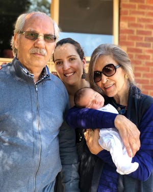 Sarvin Haghighi, center, with her parents in Melbourne shortly after son Kian was born there in March 2019. Haghighi's parents, both Iranian citizens, have been unable to visit her in the U.S. because of a travel ban imposed by former President Trump in 2017. President Biden lifted the ban on his first day in office.
