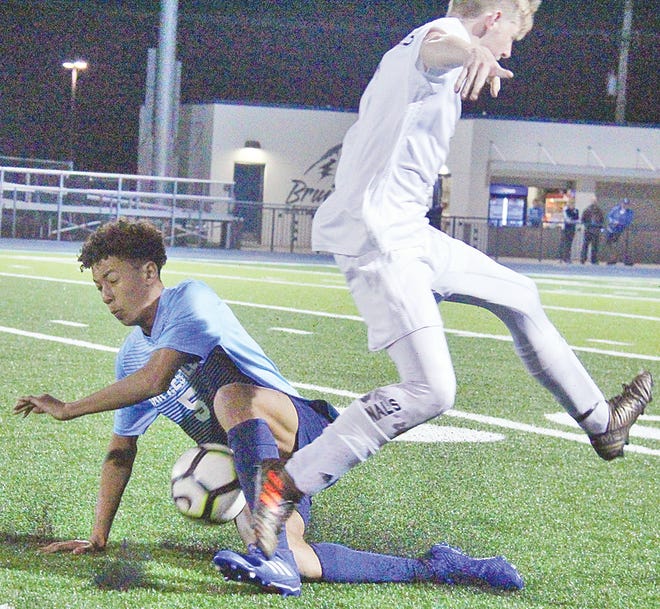 Bartlesville High School's Jalen Belong, left, possesses the ball during varsity soccer action his freshman year in 2019.