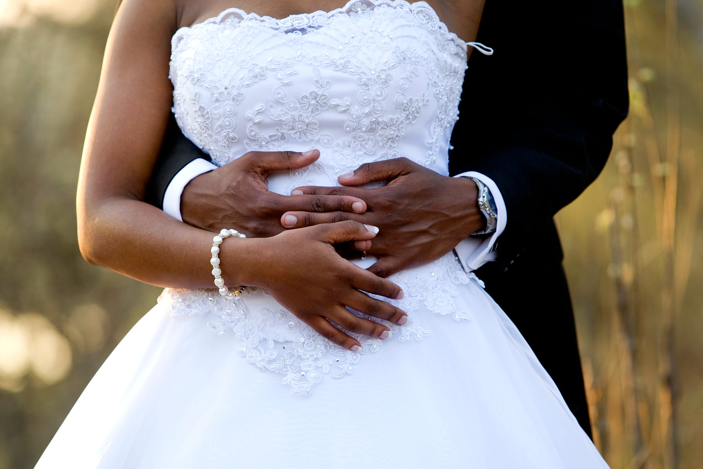 A newly wed couple holds each other in the late afternoon. COVID-19 has changed everything about weddings and will for a long time to come.