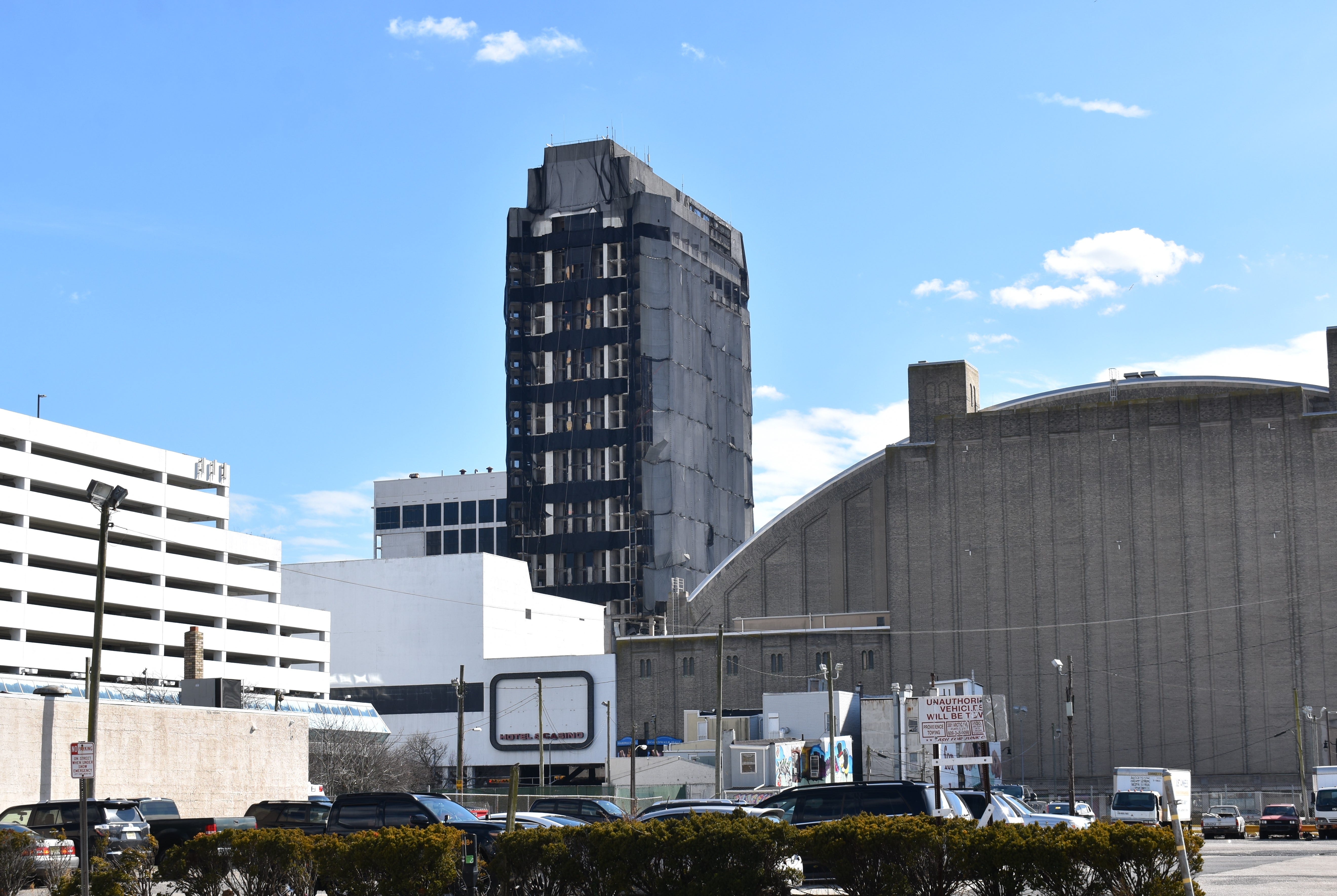 The hotel tower of Trump Plaza, being prepared for implosion, looms over  Atlantic City's Boardwalk Hall, right.