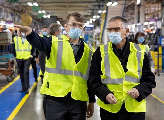 Mike Manley (left), Stellantis NV's head of America, and CEO Carlos Tavares tour the Jefferson North Assembly Plant in Detroit on Tuesday. Tavares and other members of the Stellantis leadership team visited the Detroit Assembly Complex to meet with employees and get a firsthand look at those operations, marking their first North American visit since the Stellantis merger was completed last month.