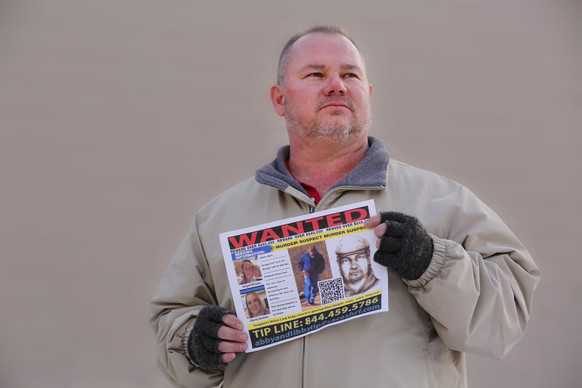 Mike Patty, grandfather of slain Delphi teen Liberty German, holds up a police poster about the case on Wednesday, Feb. 7, 2018, in Lafayette.