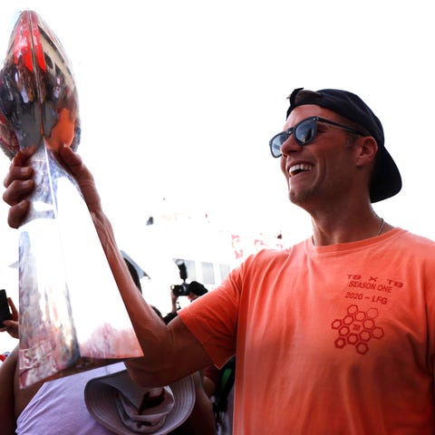 Tom Brady holds the Lombardi Trophy during the par