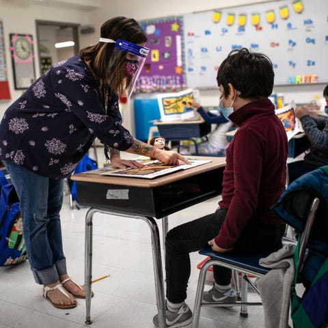 Teacher Elizabeth DeSantis, wearing a mask and fac