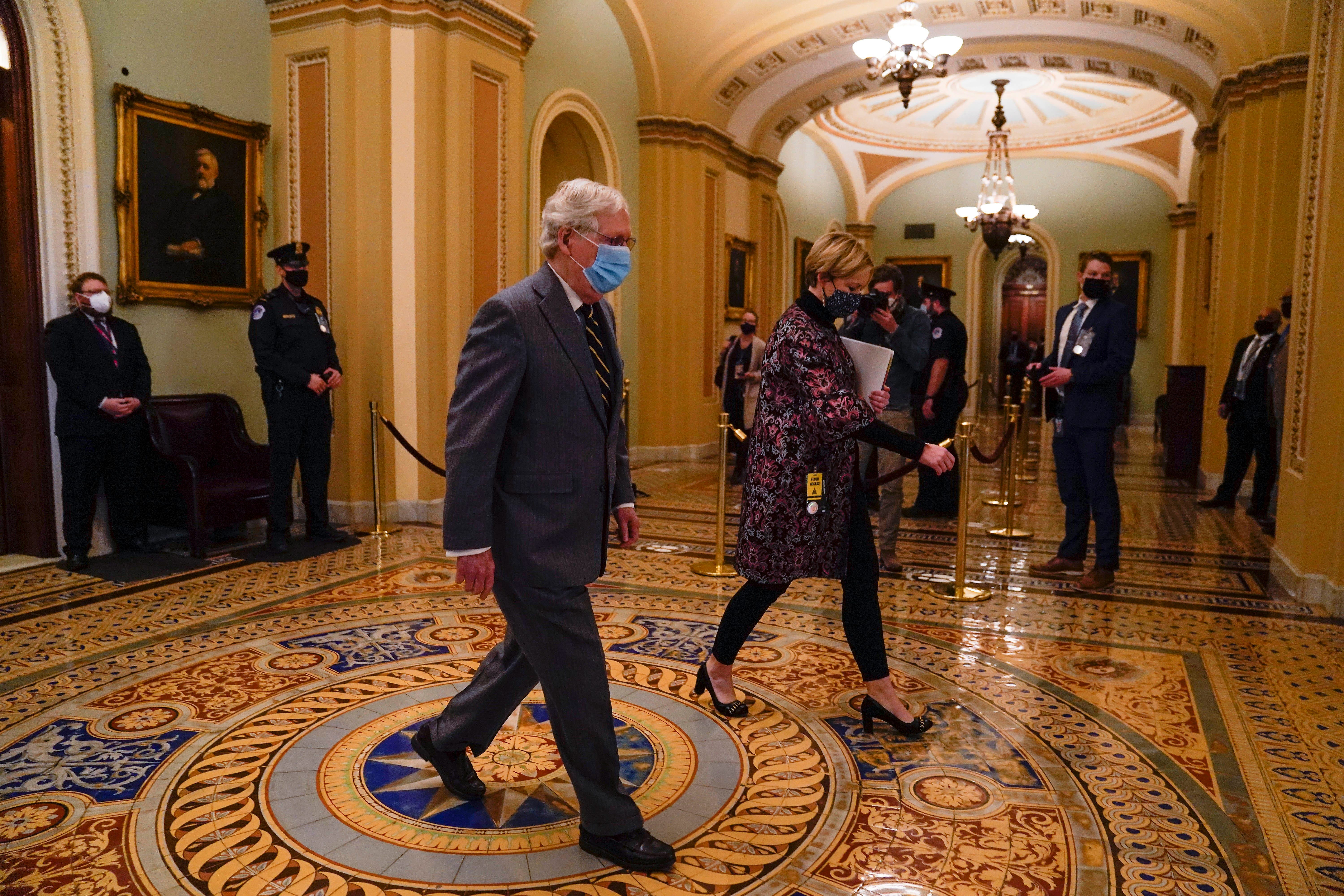 Senate Minority Leader Mitch McConnell, R-Ky., departs the Senate Chambers during a break of the second impeachment trial of former President Donald Trump as it continues at the Capitol. Trump faces a single article of impeachment charging him with “high crimes and misdemeanors” for inciting a mob that stormed the Capitol on Jan. 6, 2021.