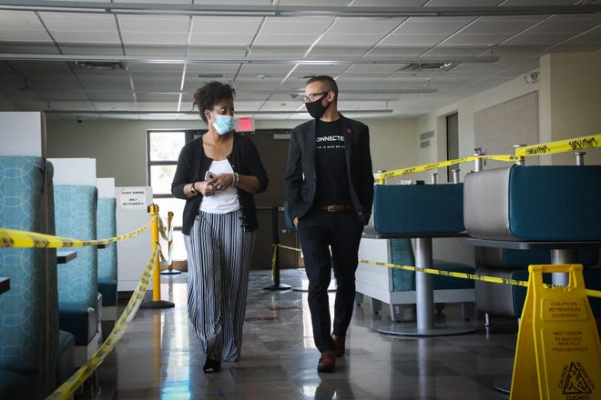 Chad Gestson, right, superintendent of the Phoenix Union High School District, walking with Cheri Hardwick, principal at the Academies at South Mountain.