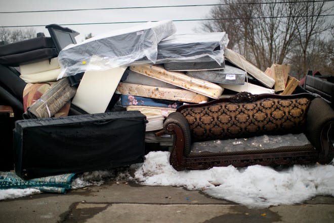 Beside the dumpsters outside the Whispering Oaks apartments on Monday are mattresses, layers and bed frames.  They belonged to families who had to leave the apartment complex after their month-to-month leases were terminated by the management, who wants to renovate the buildings.