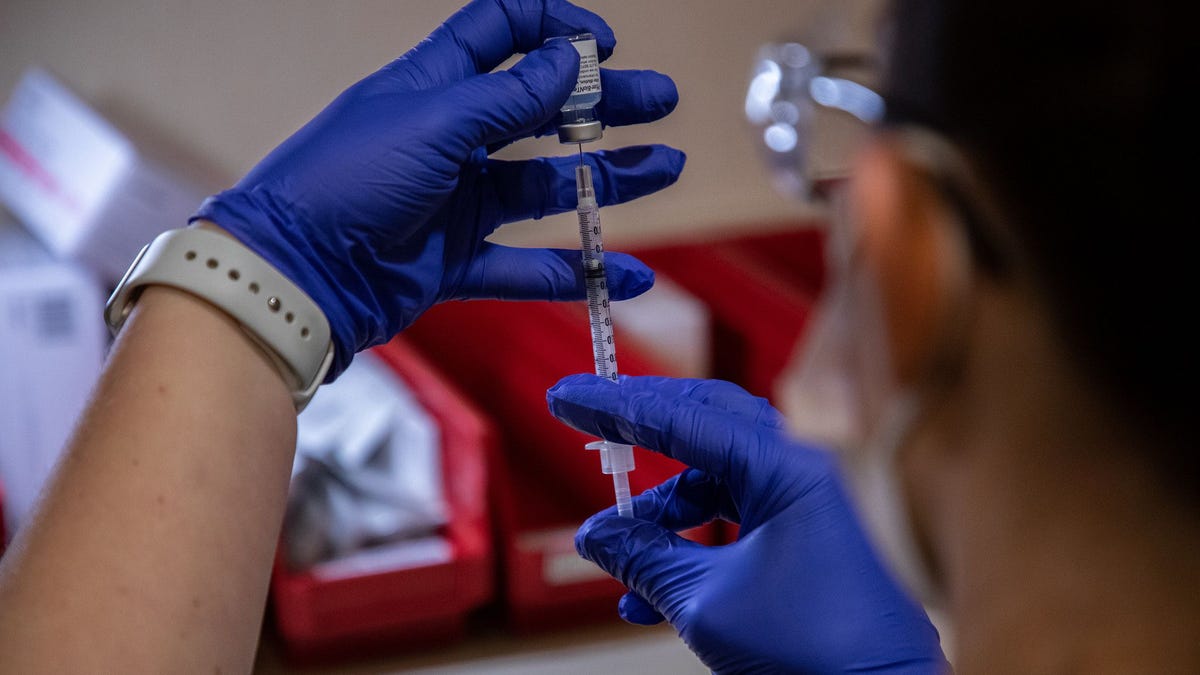Amita Health Presence Medical Center pharmacy manager Nicole Costa prepares a COVID-19 vaccine to be administered to medical personnel on Dec. 16, 2020.