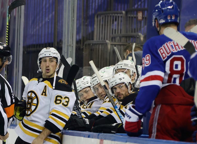 Boston Bruins' Brad Marchand (left) and New York Rangers' Pavel Buchnevich chat during the third period of an NHL hockey game Wednesday in New York. Marchand had the last word with a game-winning goal in overtime.