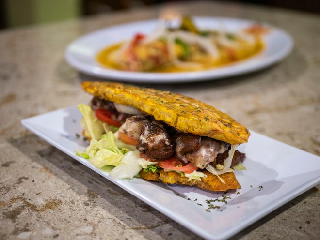 A crispy plantain sandwich is stuffed with fried turkey at Alberte's Restaurant in suburban Lake Worth. WILKINE BRUTUS