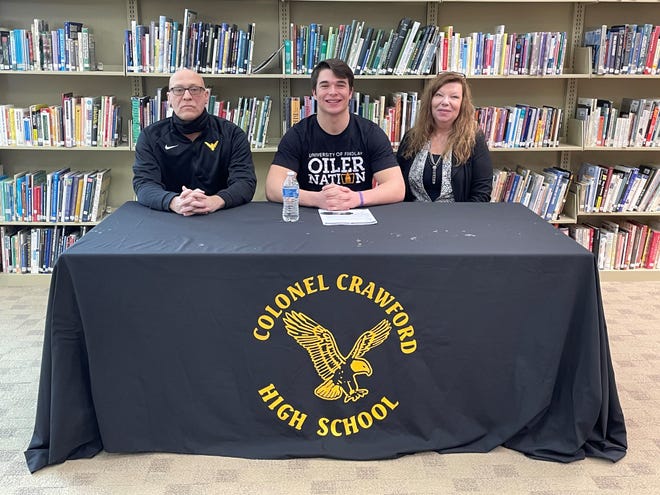 Colonel Crawford's Tristan Cross inks his letter of intent to continue his football career at the University of Findlay.

(L to R): coach Ryan Teglovic, Tristan Cross, mother Retha Hensley