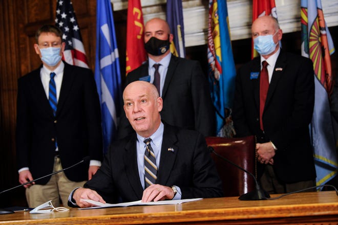 Montana Gov. Greg Gianforte speaks with the press on Wednesday, Feb. 10, 2021 in the State Capitol in Helena, Mont. Gianforte said he would lift a statewide mask requirement later this week after he signed a bill that is intended to protect businesses and health care providers from coronavirus-related lawsuits. (Thom Bridge/Independent Record via AP)